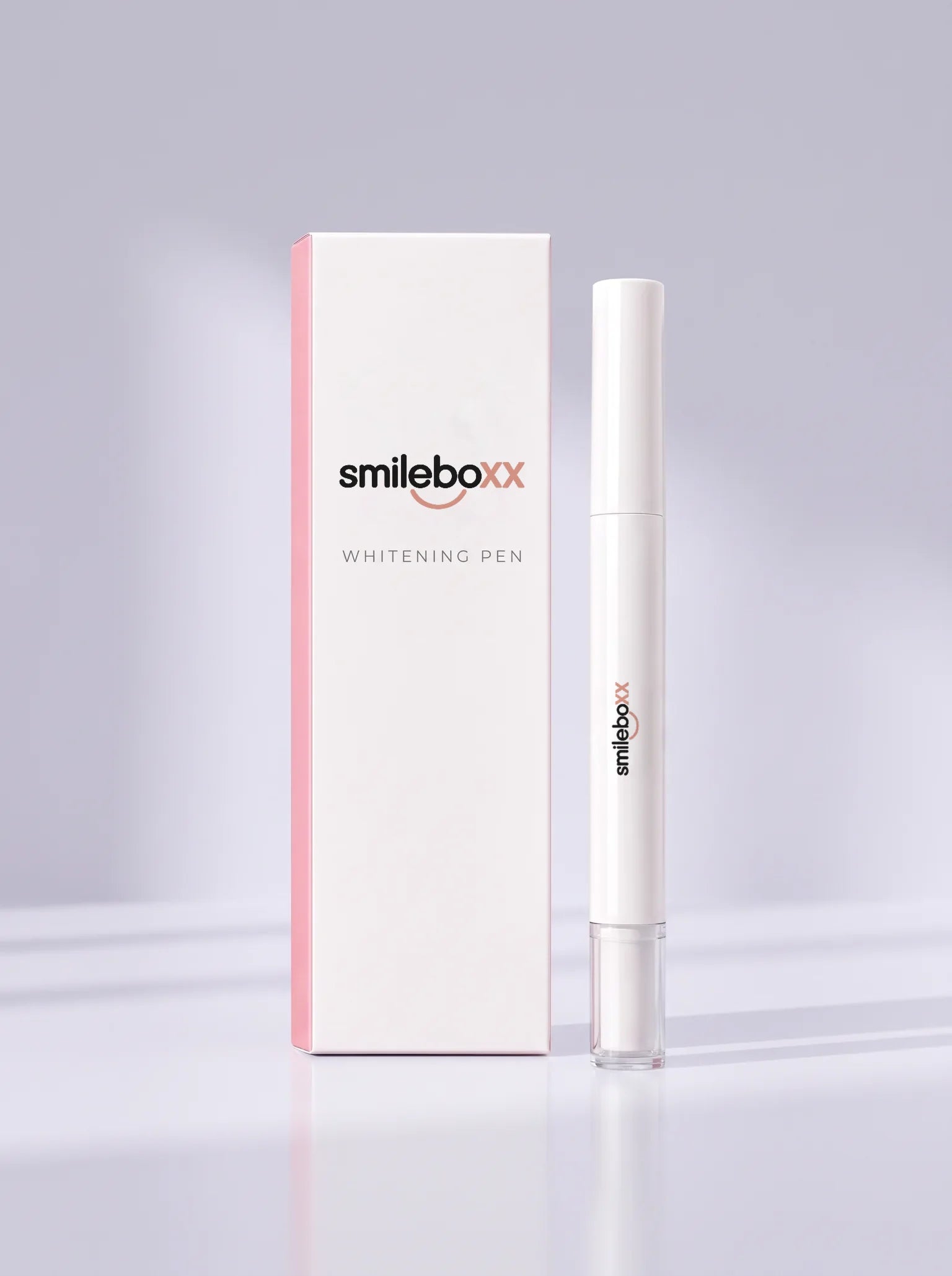 A carton printed smileboxx and WHITENING PEN standing beside a white applicator pen