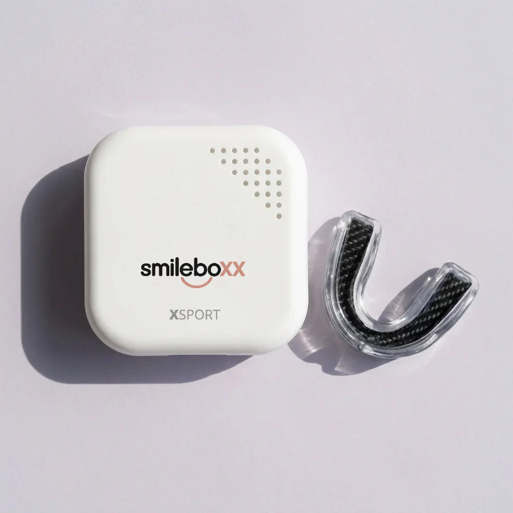 A white vented case printed smileboxx and XSPORT beside a carbon-fiber sports guard