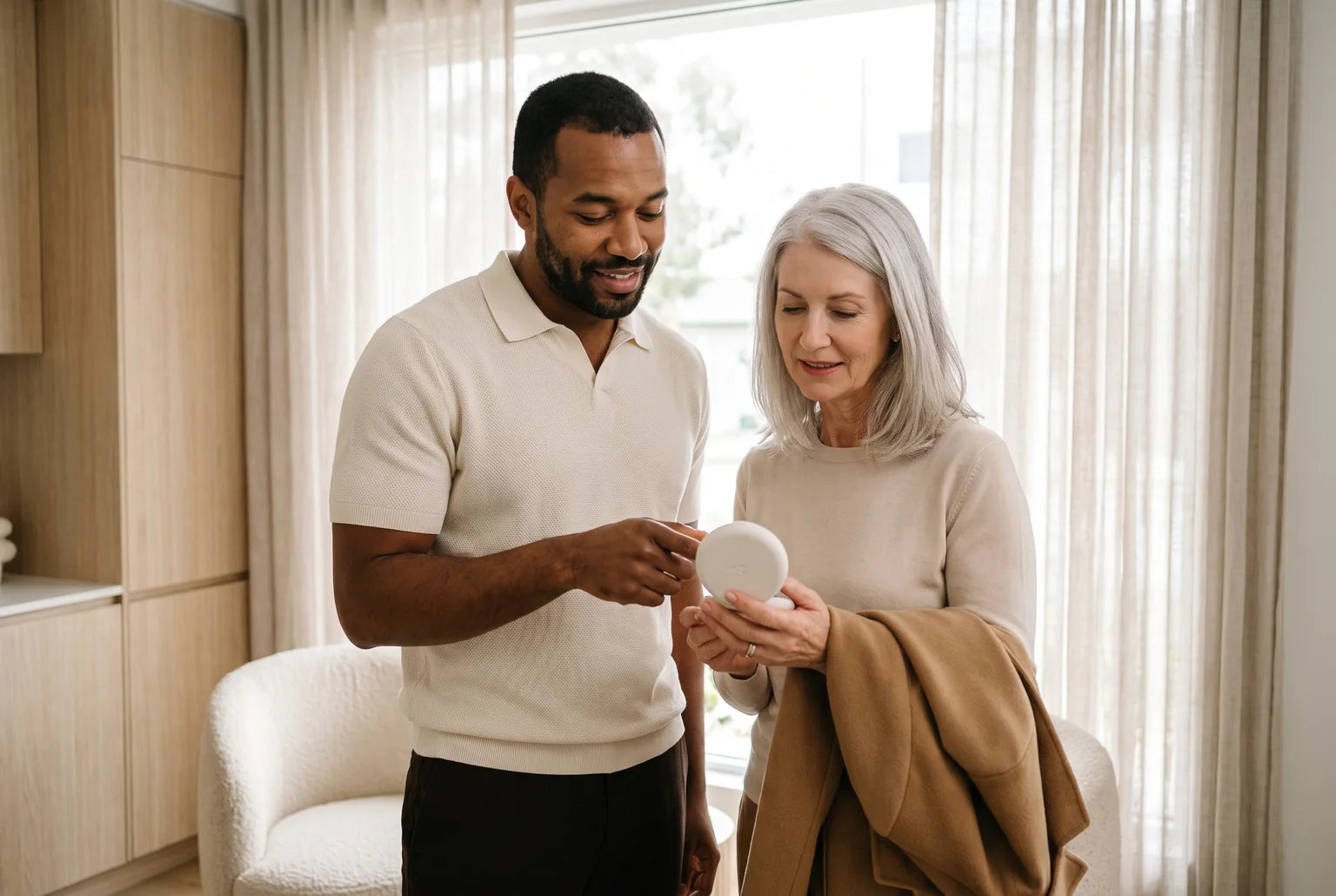 A smile coach and a client looking at an open aligner case by a bright window